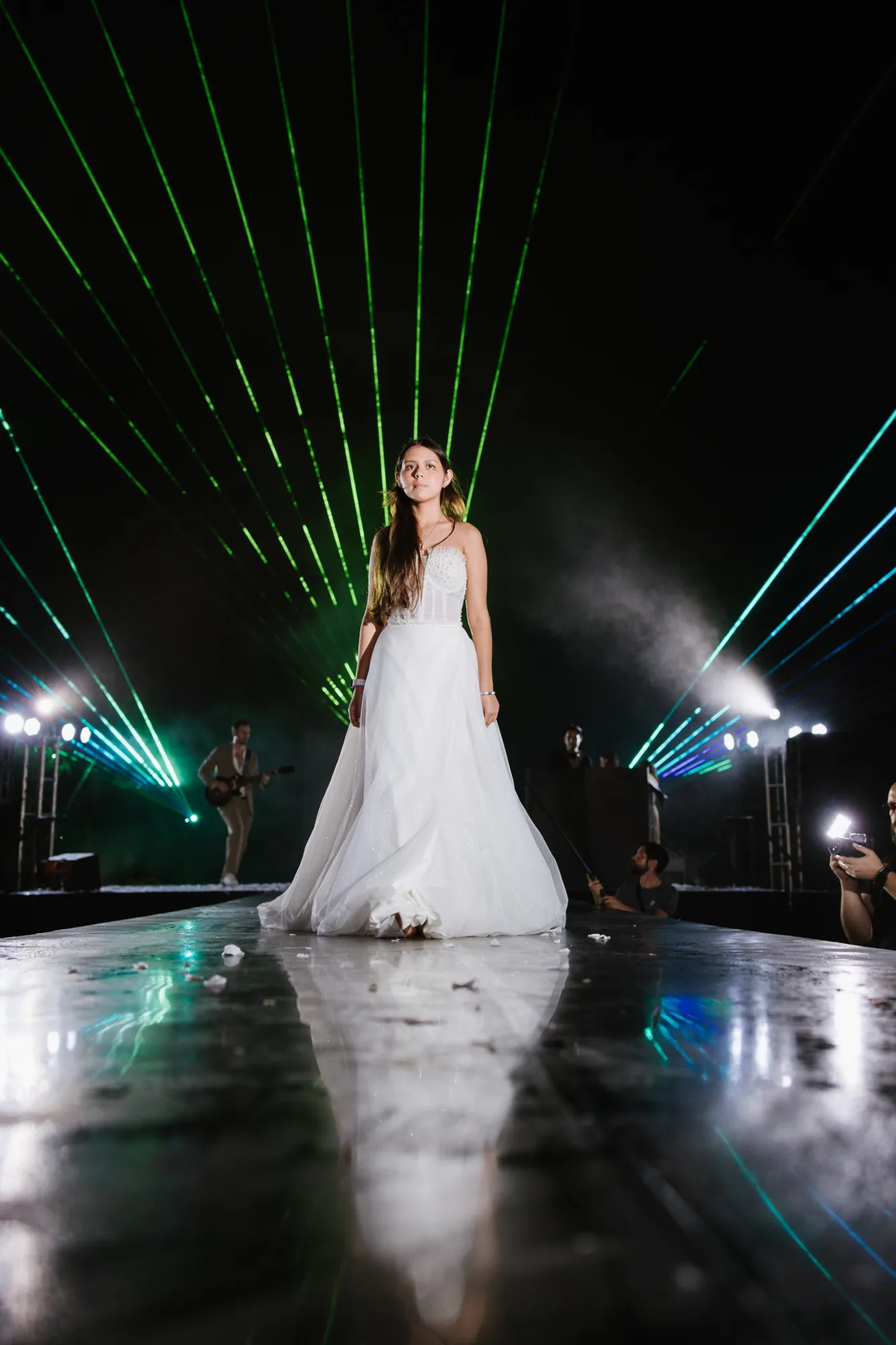A bride in a full tulle gown on the illuminated runway